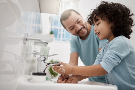 Father and son washing hands